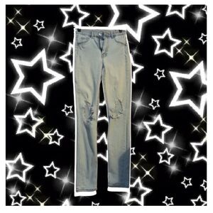 loose light wash distressed jeans with holes on the knees